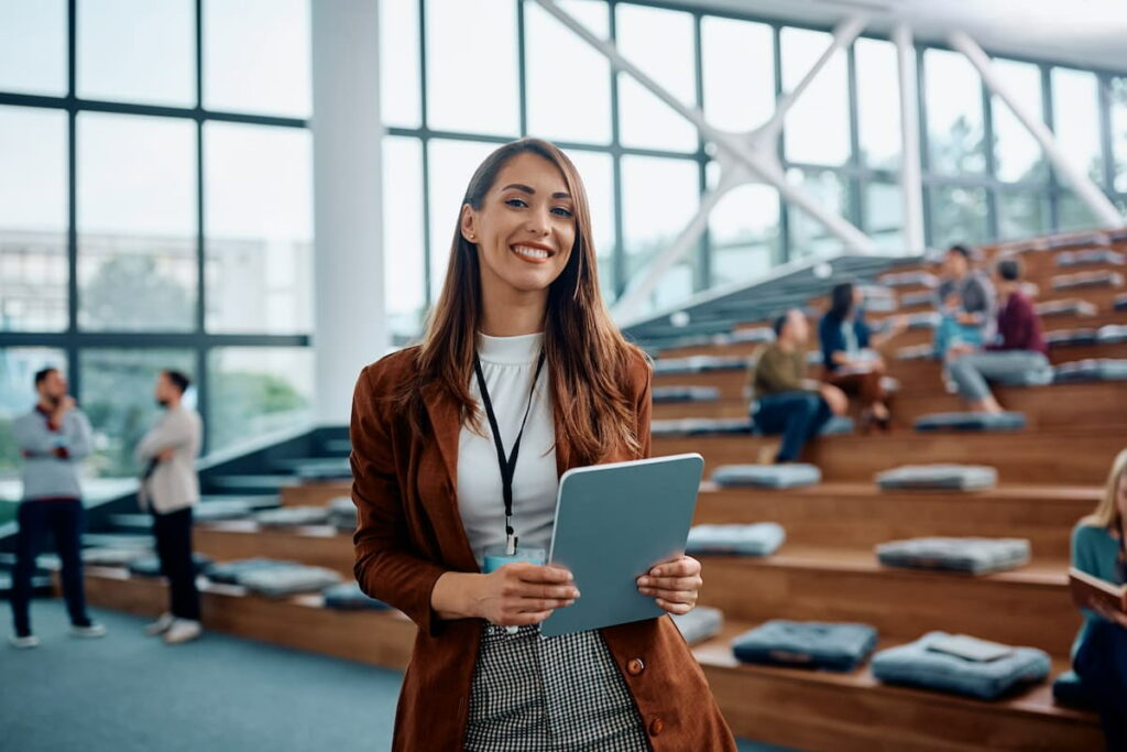 A happy businesswoman attending a conference in a convention center.